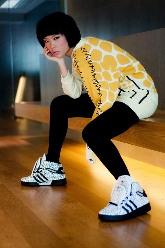 Female model in yellow fashion photoshoot pose