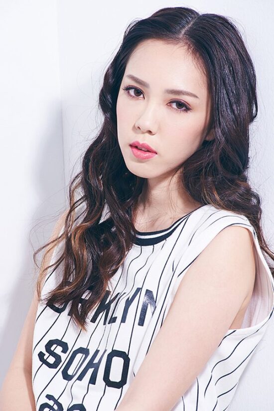 Female model in white tank top studio portrait