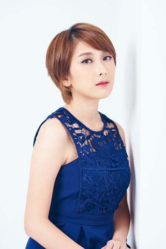 Female model studio photoshoot in sleeveless blue top