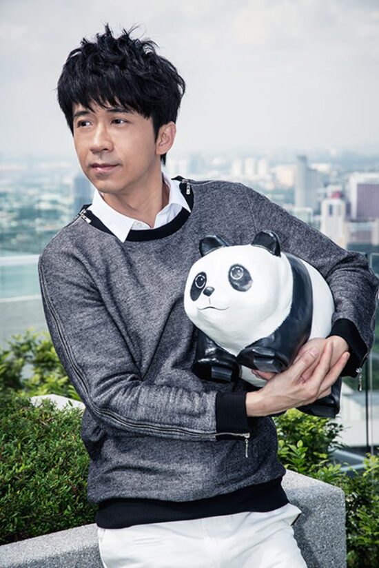 Male model outdoor portrait with panda bear prop