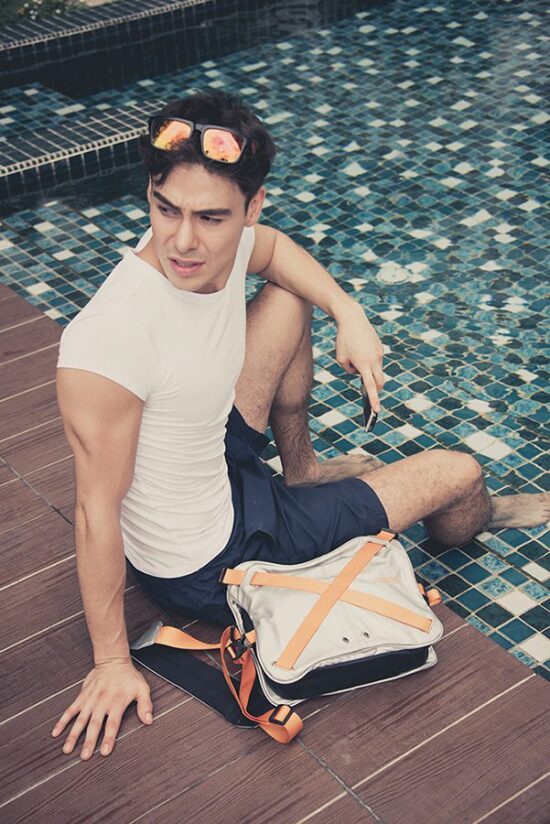 Male model outdoor lifestyle photoshoot with red backpack