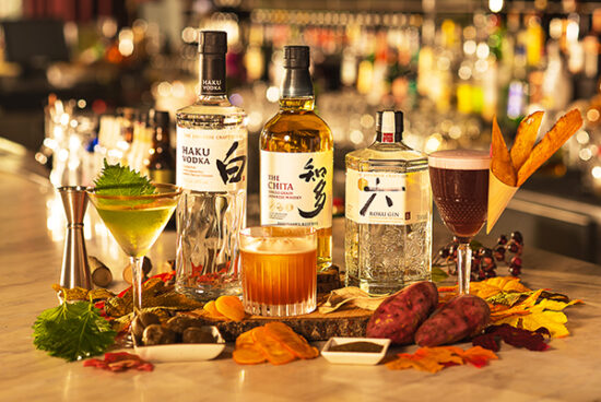 Japanese whiskey bottles with citrus garnish – cocktail product photography.