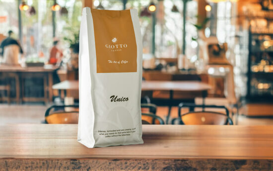 Giotto coffee bag on wooden table in café – lifestyle product photography.