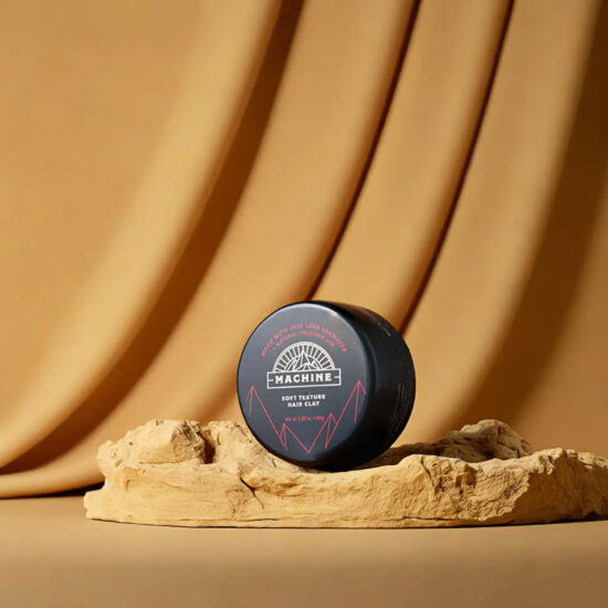 Machine Blue Hair Cray container on golden fabric – beauty product photography.
