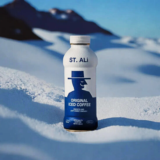 Iced Coffee bottle on snow background – beverage product photography.
