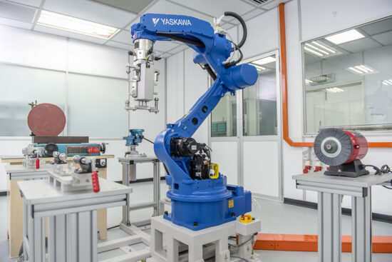 Blue robotic arm in automated factory production line