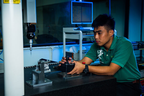 Worker operating high-tech inspection machine